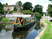 A narrowboat passing Millman swing bridge