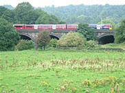 A train crosses the River Aire
