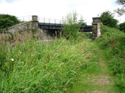 Approaching old railway bridge with crossing for farmer