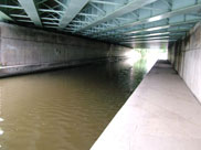 Under the wide M61 motorway bridge