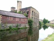 Old stone and brick built mill sadly in decay