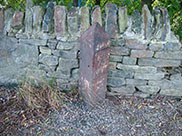 Another old and damaged mile marker
